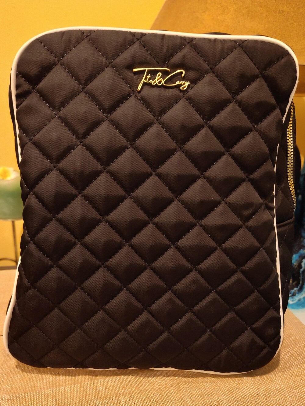 Quilted Black Backpack with Gold Logo